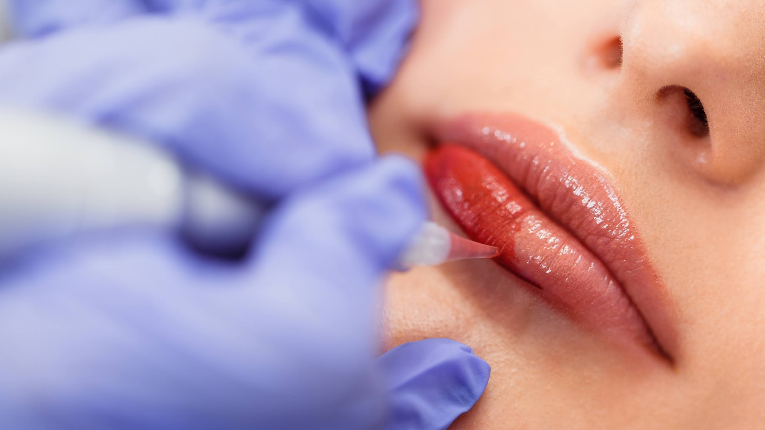 Close-up of a client receiving a precise lip color application at Bonita Hub, showcasing expert beauty services in Boston.