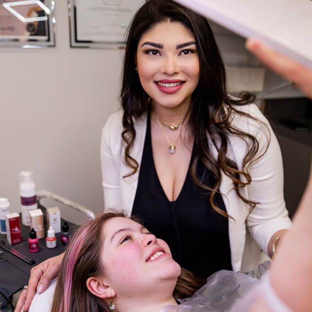 Confident beauty professional at Bonita Hub holds a lip liner, ready to enhance a client's natural beauty in Boston.