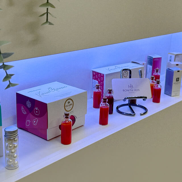 Bonita Hub's premium beauty products on display, including vibrant red bottles and branded packaging, reflecting quality care.