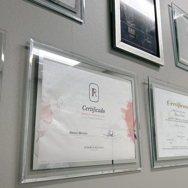 Wall of fame displaying framed professional certificates and accolades, showcasing the expertise at Bonita Hub.