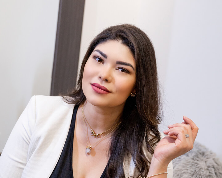 Confident beauty professional at Bonita Hub holds a lip liner, ready to enhance a client's natural beauty in Boston.